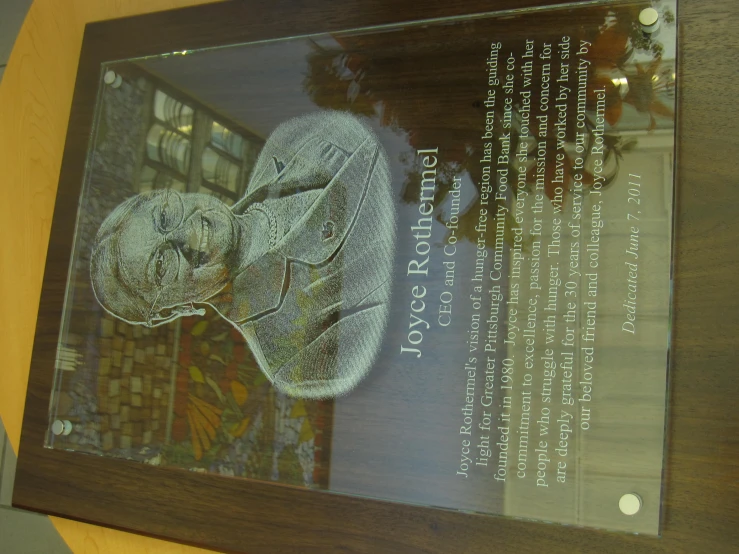 a plaque with a portrait of joyce robertson is displayed