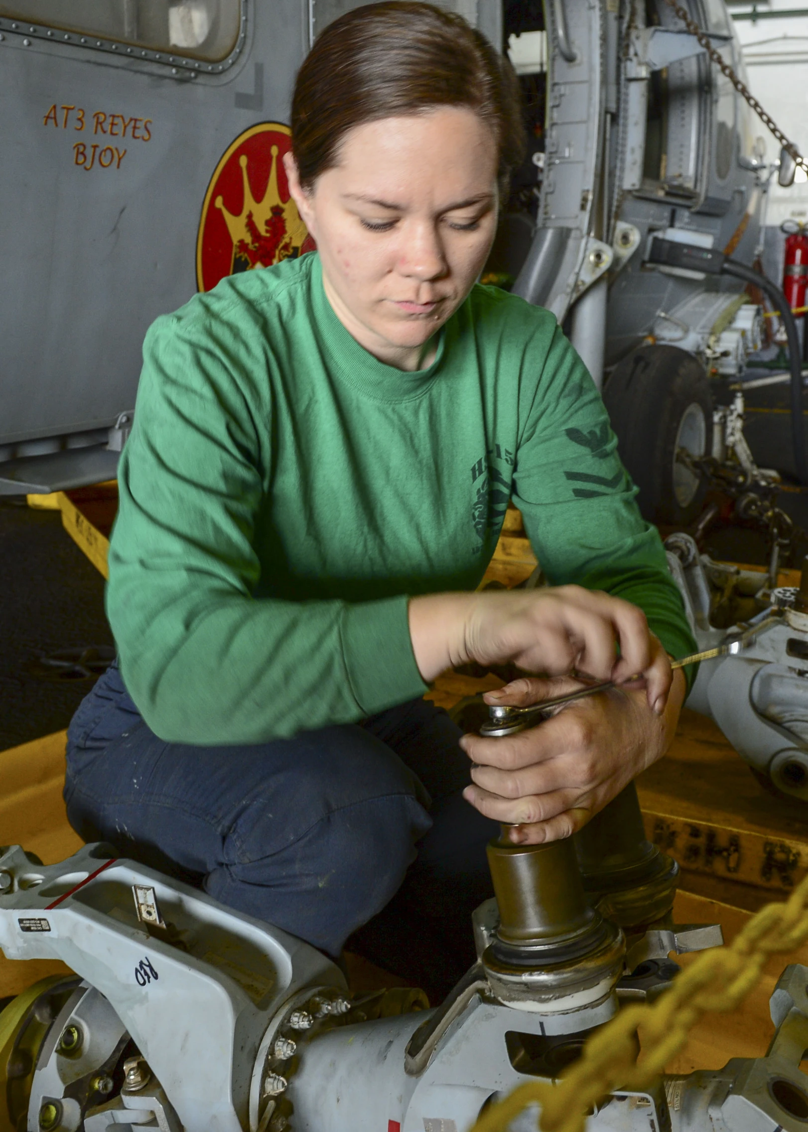 a woman working on an object with some tools