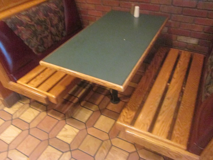 a bench and table with two benches on the ground
