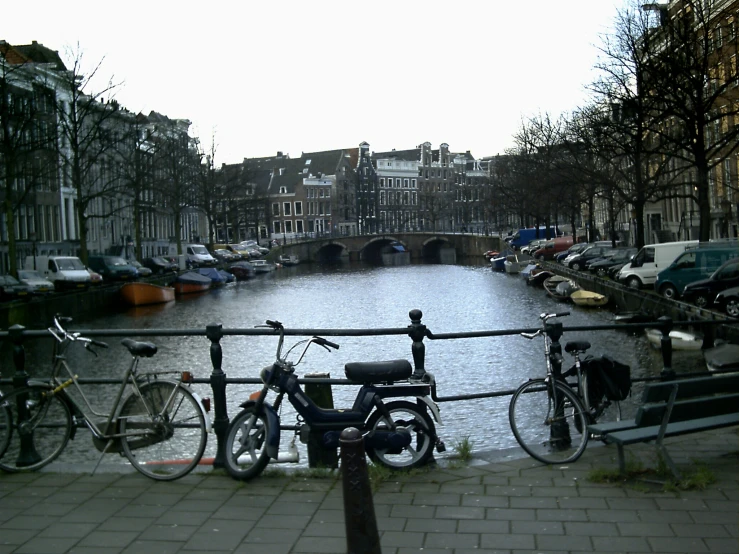 a city is lined with boats and bicycles
