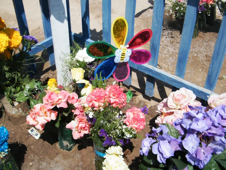 this is an arrangement of flowers and a erfly decoration