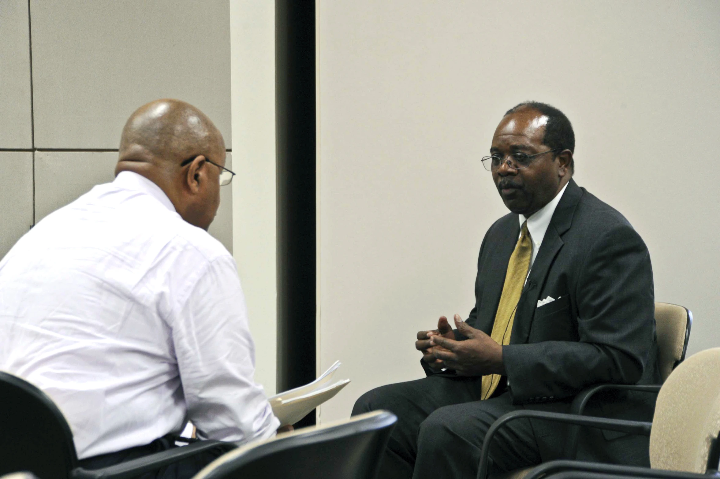 two men sitting down having an event