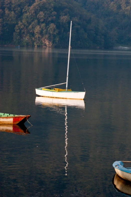 two small boats floating on top of a lake