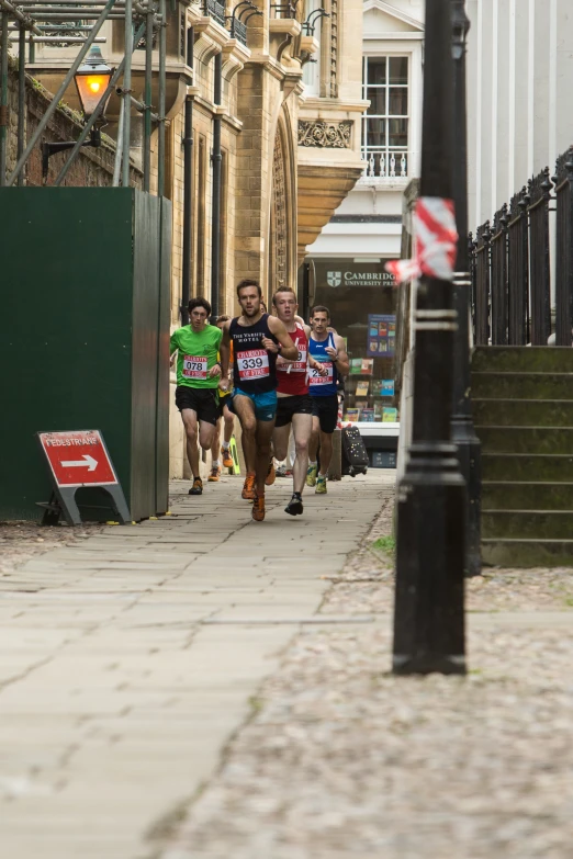 some people are running on a city sidewalk