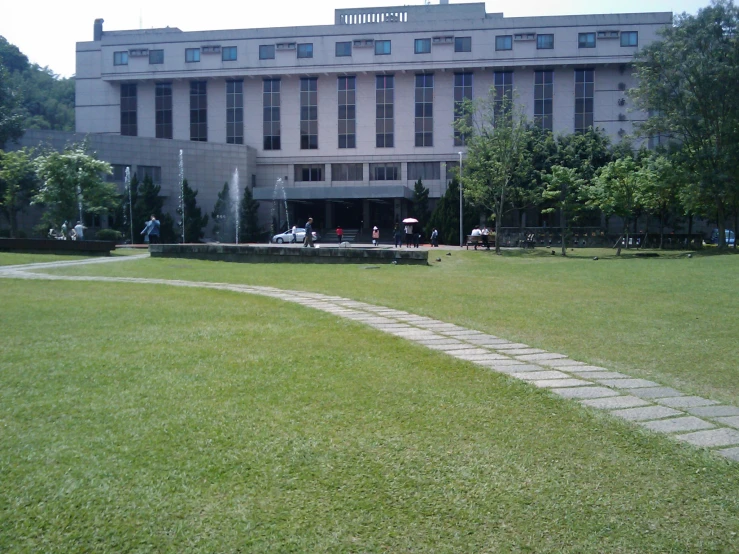 a stone walkway leading to a large building