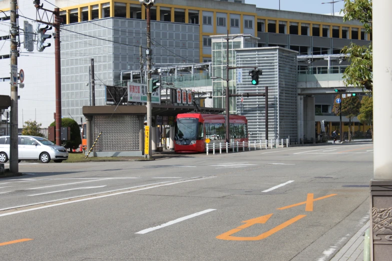 a bus parked at an intersection in front of buildings