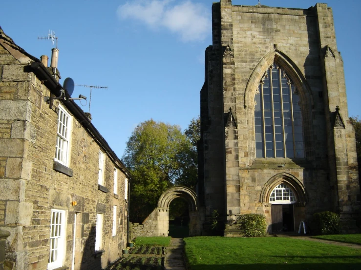 a very tall cathedral like building surrounded by brick buildings