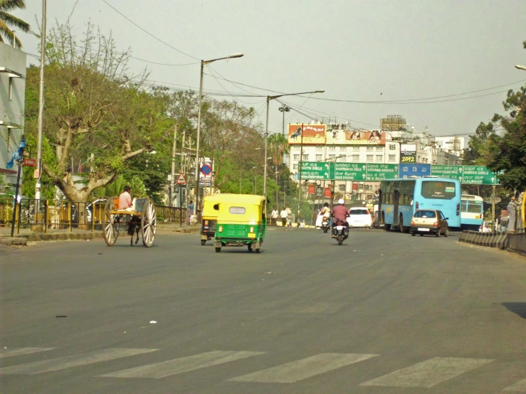 a busy street with cars, bikes and motorcycles