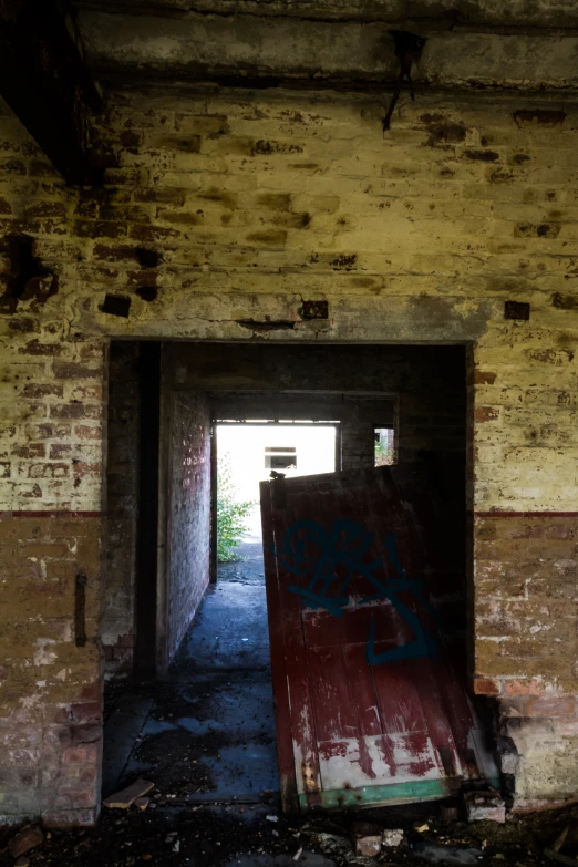 a tunnel entrance to a building with graffiti