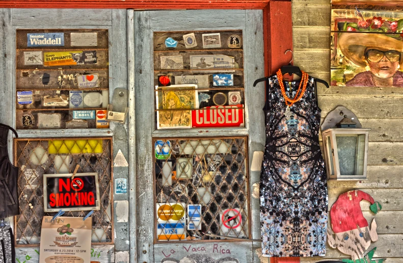 a colorful shop in the city with posters on the front