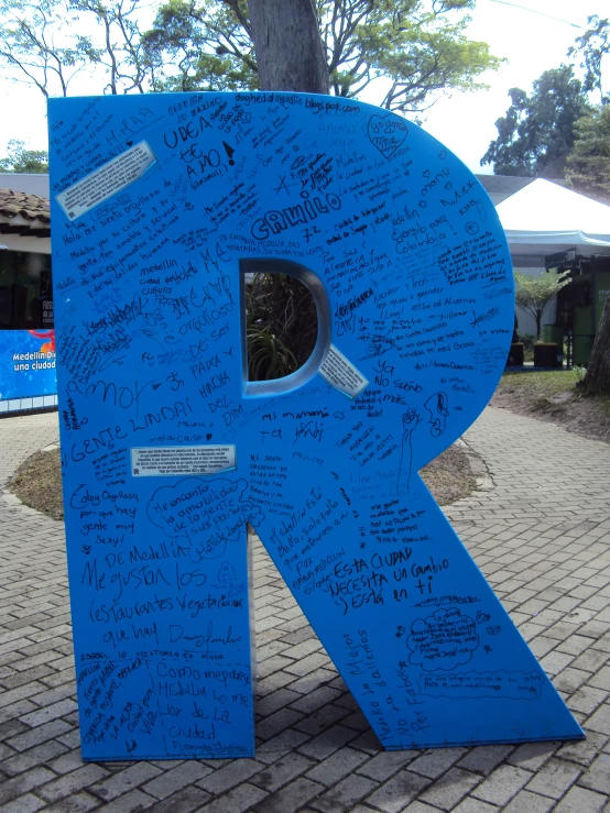 a large blue sign in front of a building