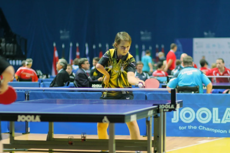 a man playing table tennis is seen here