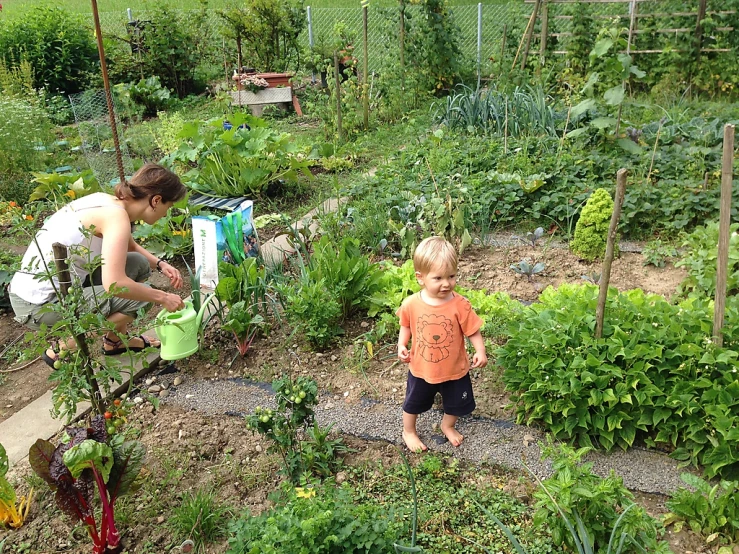 the woman and child are working in the garden