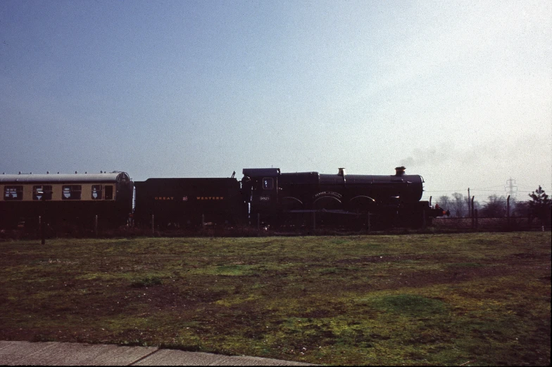 a train with the caboose sitting alone in a field