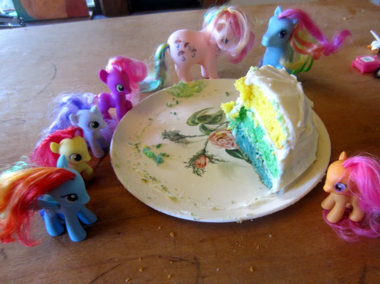 a large slice of cake with toy horse figurines on top