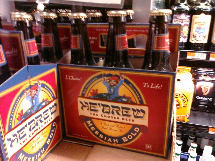 a group of beer bottles on a rack in front of a refrigerator