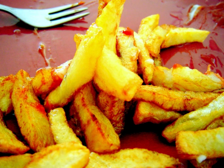 some fries and ketchup with a fork