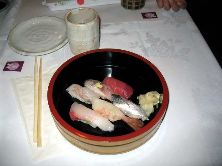 a japanese dinner of sushi and rolls on a white table