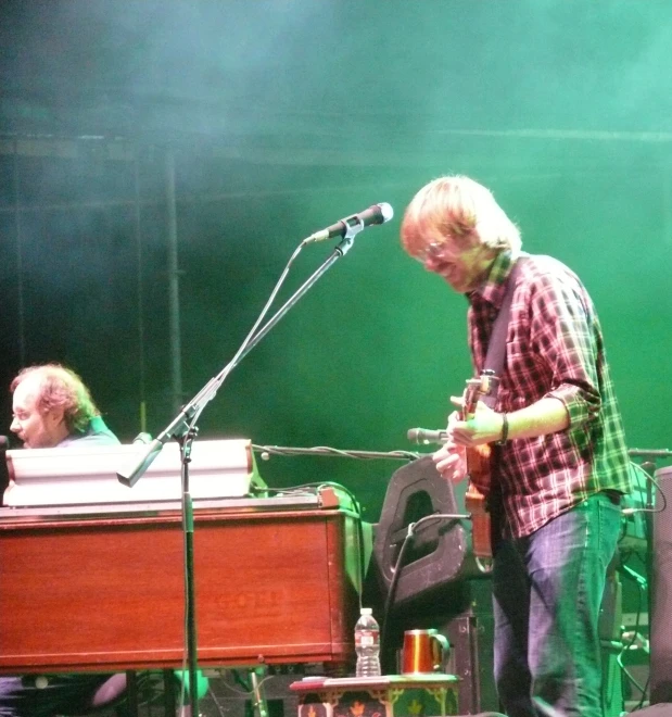 two men standing near each other on a stage