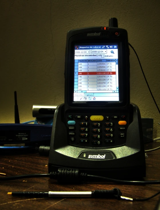 an open cellphone sitting on top of a computer desk