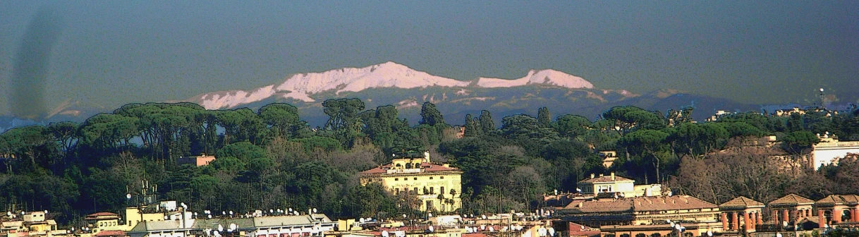 the snow covered mountains stand in the distance