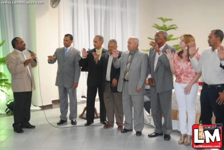 group of older men singing with microphone and clapping