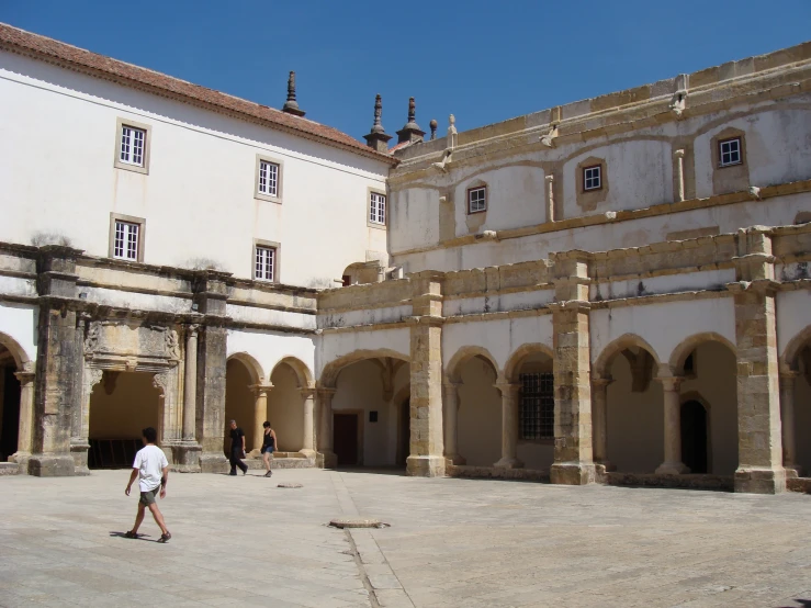 the courtyard in the middle of a building with columns and arches