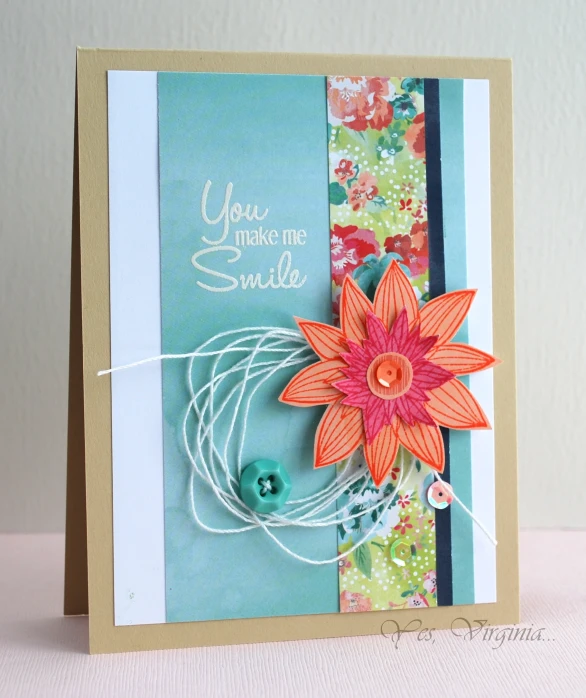 a colorful card with an ornament flower on it