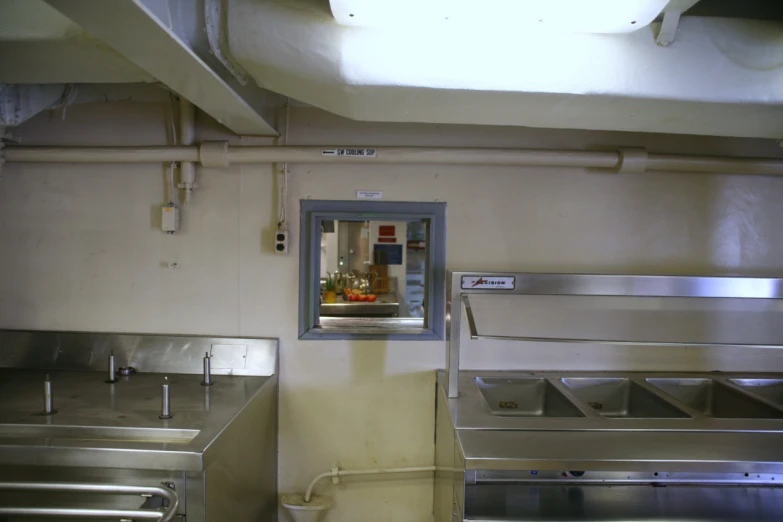 this commercial kitchen contains stainless steel and a wall mirror