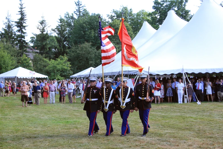 uniformed men in uniforms standing at attention with flags