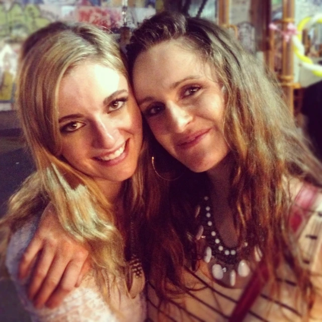 two beautiful young women hugging in a shop