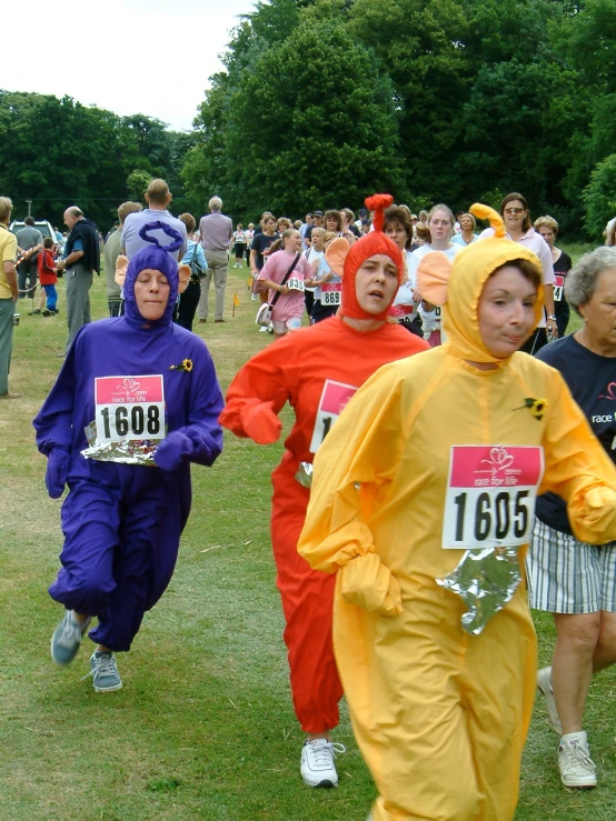 a group of people in costume run through the grass