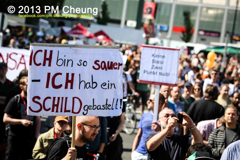 a crowd of people with signs and standing around