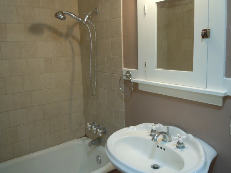 a bathroom has a sink, mirror and tub