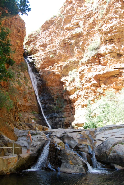 a waterfall falling down into a rocky gorge