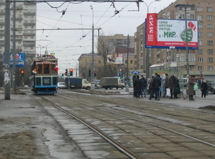 the trolley moves along the tracks in an empty urban setting