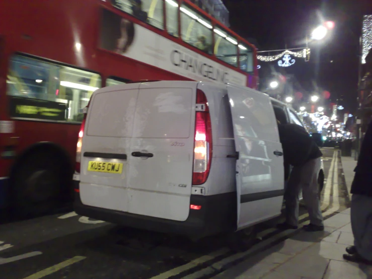 a van that is sitting in front of a bus