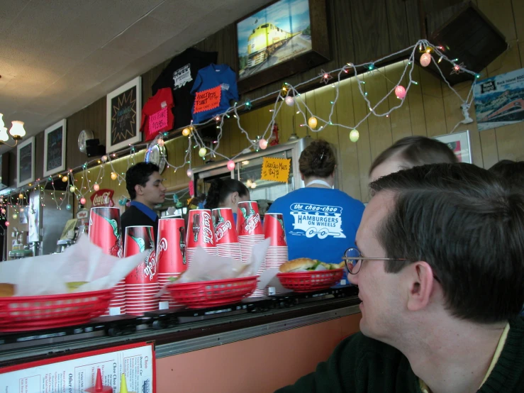 a restaurant is being served red and white cups with red rims