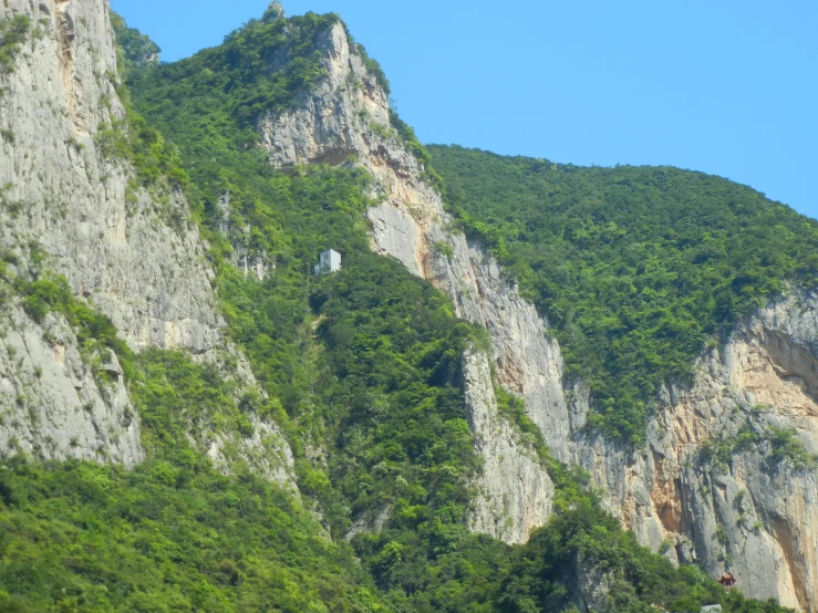 tall mountains sitting high up on the side of a mountain