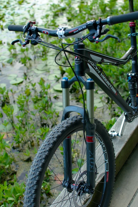 a bicycle sitting on top of a wooden bench