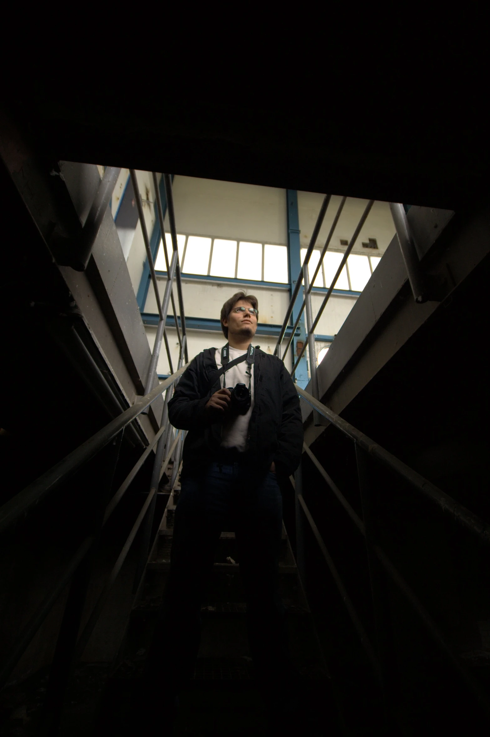 man standing on a stairwell in the dark