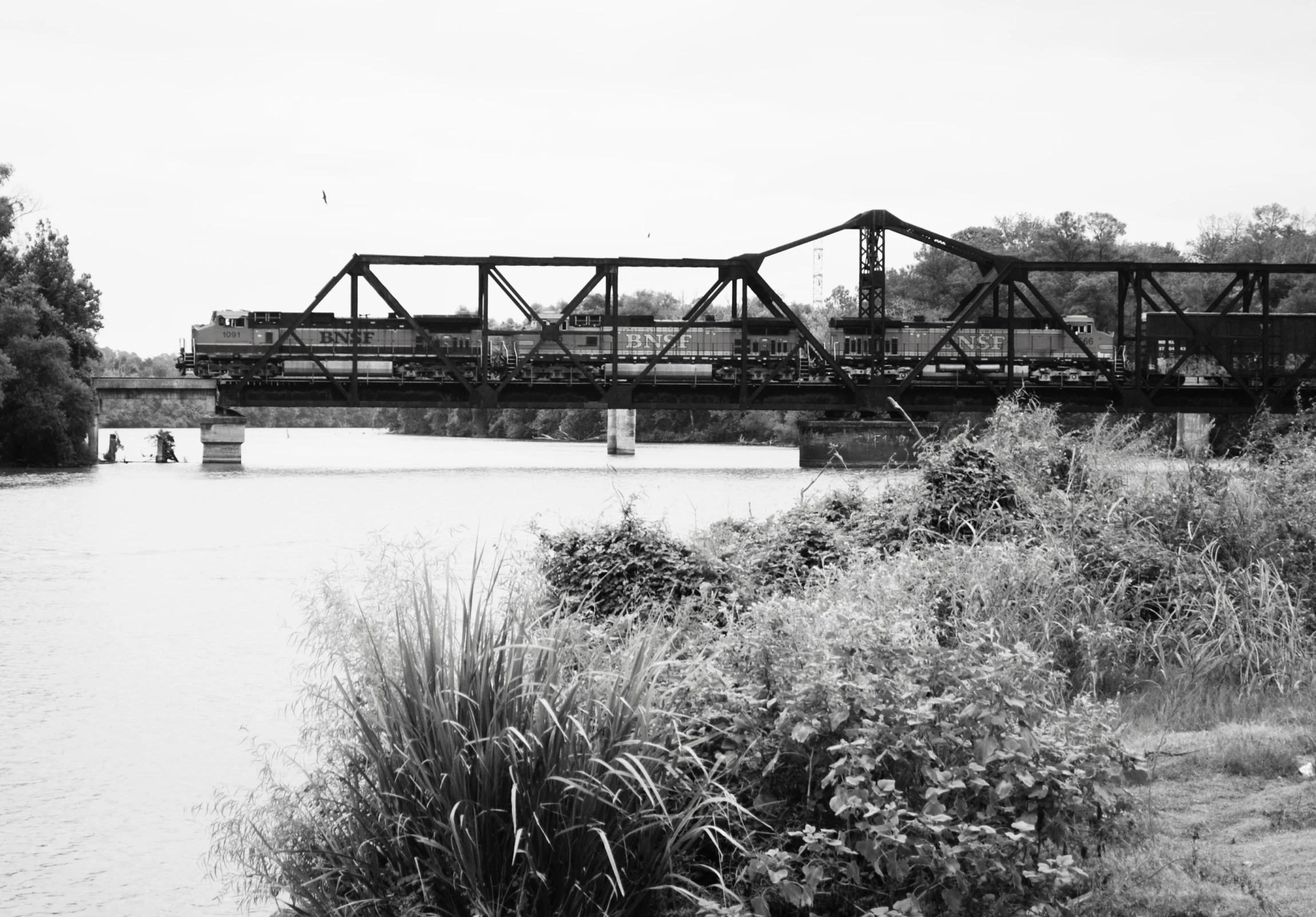 the old train goes across the bridge over the water