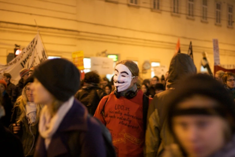 people with masks walking and wearing protest signs