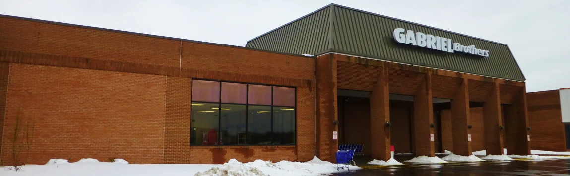 an office building sits surrounded by snow on a wet day