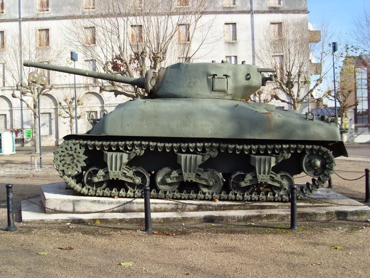 a vintage tank on display in a park