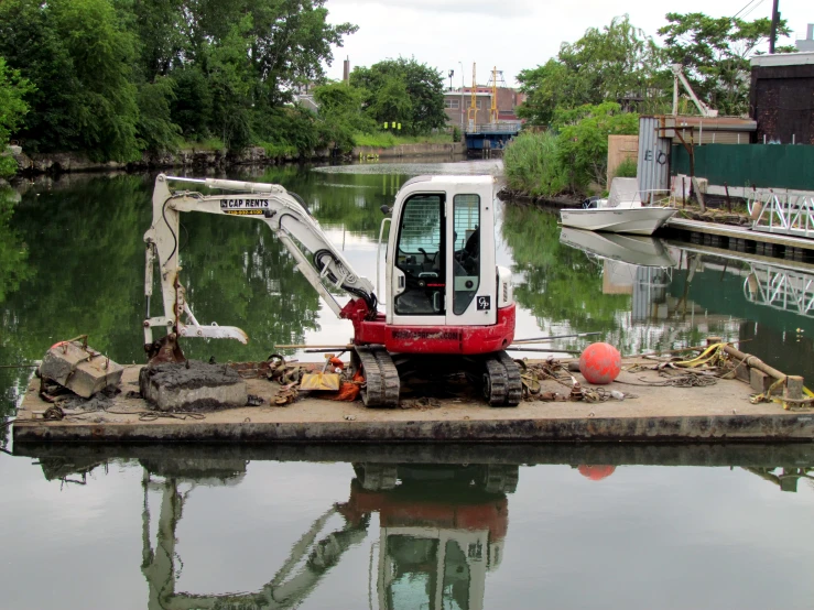 a boat sits in a body of water near construction