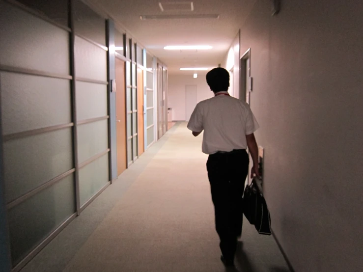 a man with a bag walking down an aisle