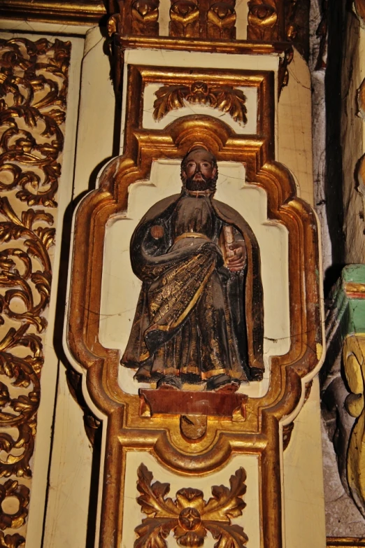 a statue of a person dressed in a black and gold outfit