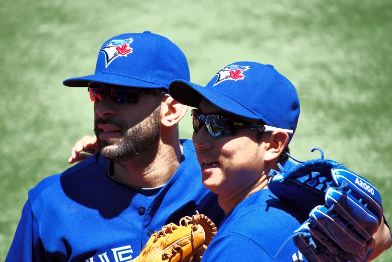 two toronto blue jays players standing on the field