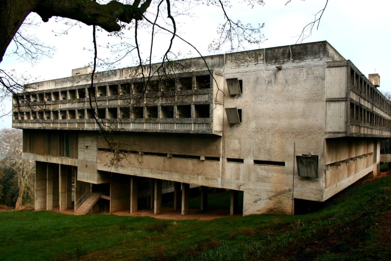 an old concrete building with multiple balconies on top